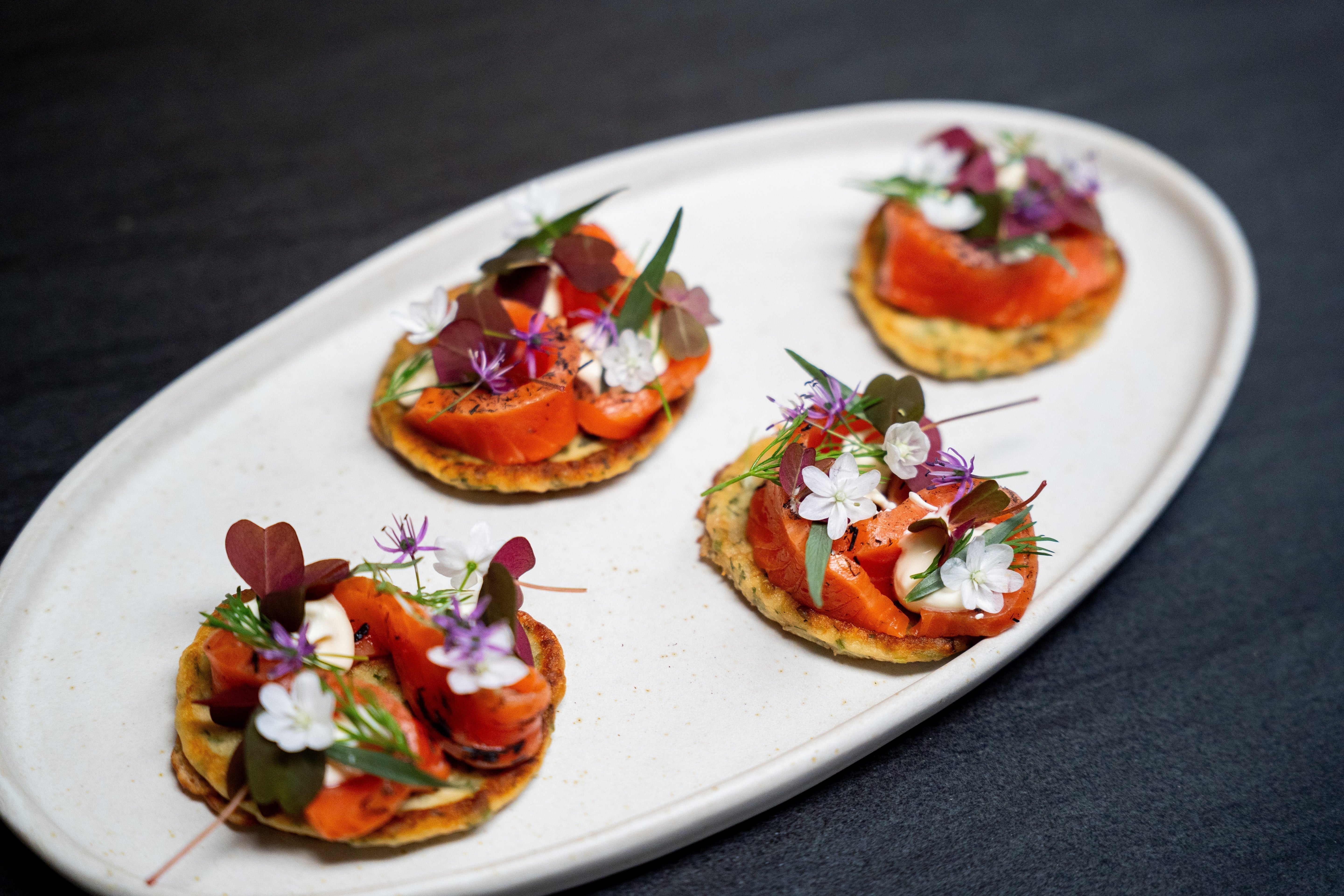 Herb blinis with hay-smoked salmon and citrus cream
